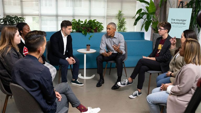 students sitting in meeting with former president barack obama
